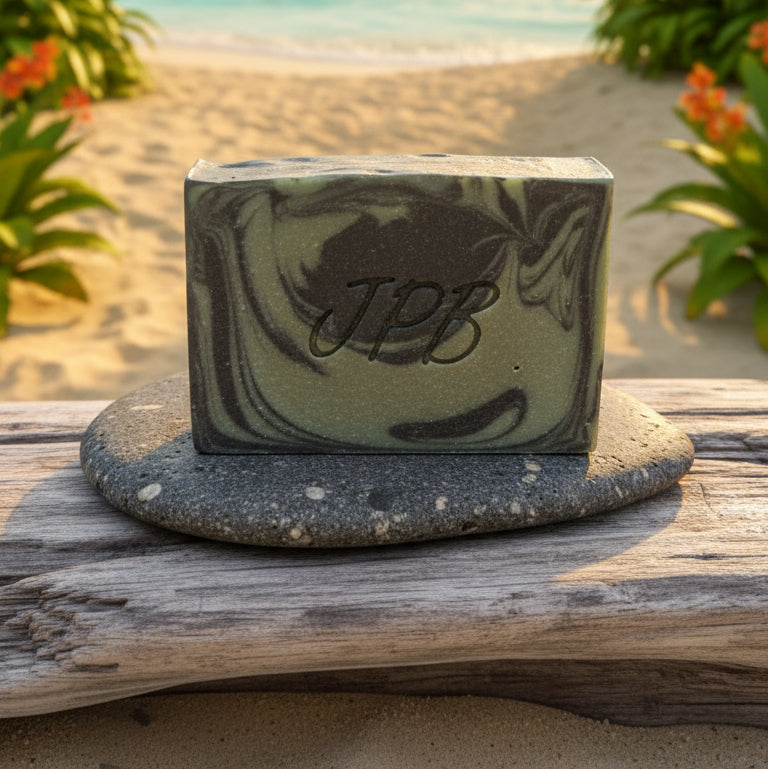 Green marbled soap bar with a logo on a gray surface